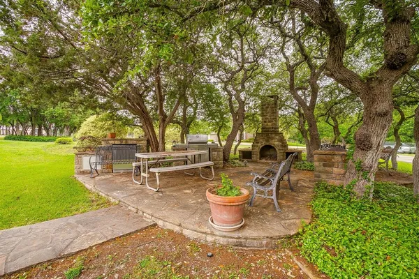 a view of a backyard with sitting area and garden