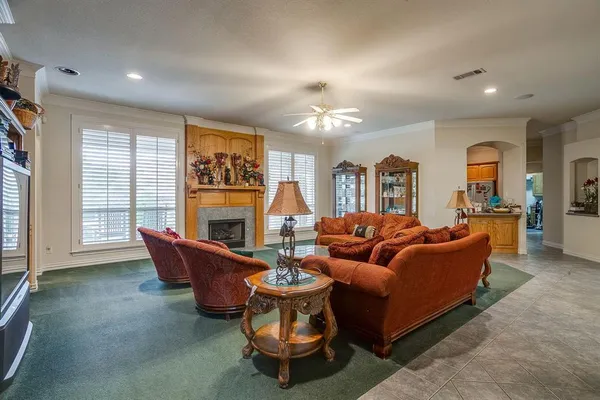 a living room with furniture a fireplace and a large window
