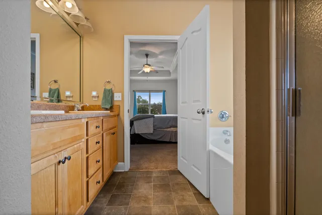 a en suite bathroom with a double vanity sink a mirror and a shower