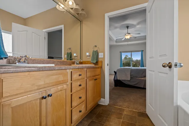a en suite bathroom with a sink a large mirror and vanity