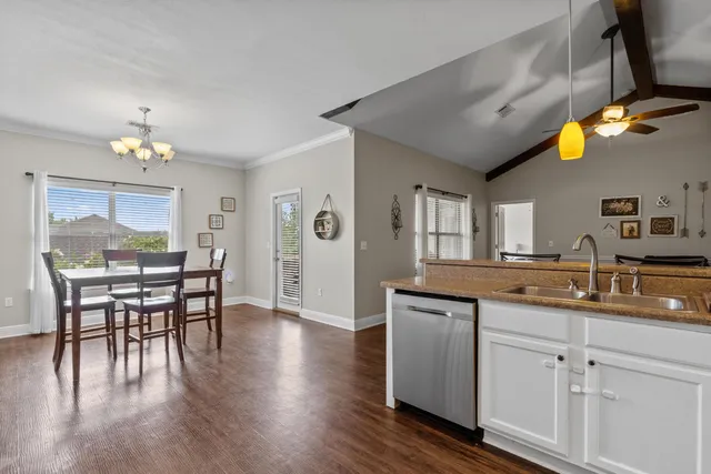 a kitchen with a sink cabinets and wooden floor
