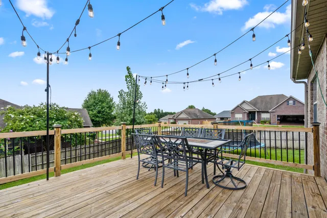 a view of a roof deck with table and chairs with wooden floor
