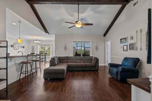 a living room with furniture and wooden floor