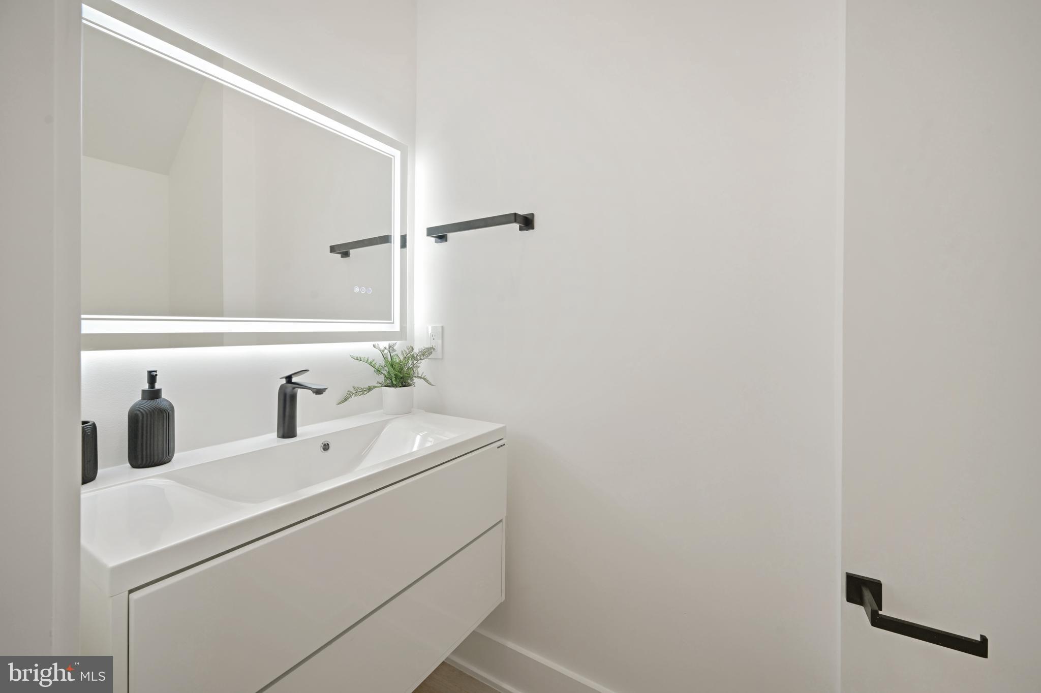 517 Montana Avenue Northeast, Unit 3C Washington, DC 20017 - Photo 22 of 54 a bathroom with a sink and a mirror