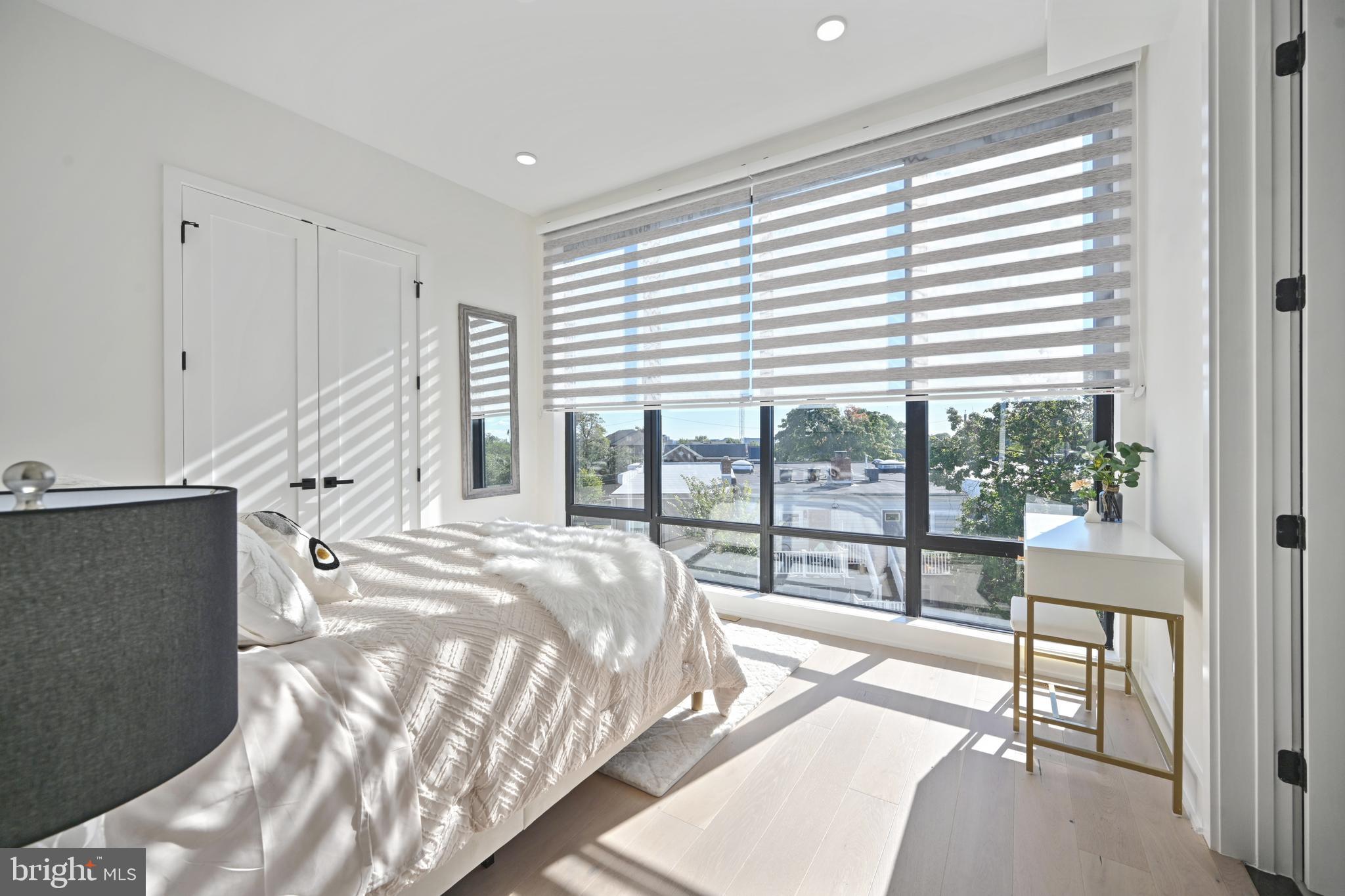 517 Montana Avenue Northeast, Unit 3C Washington, DC 20017 - Photo 23 of 54 a spacious bedroom with a bed and a large window
