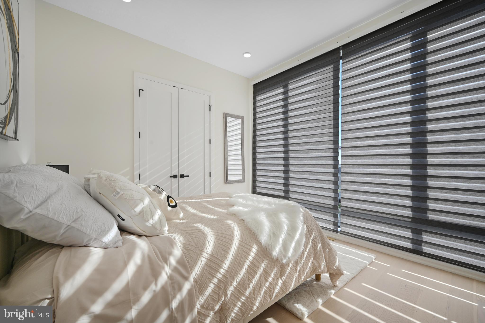 517 Montana Avenue Northeast, Unit 3C Washington, DC 20017 - Photo 26 of 54 a bedroom with a bed and a window