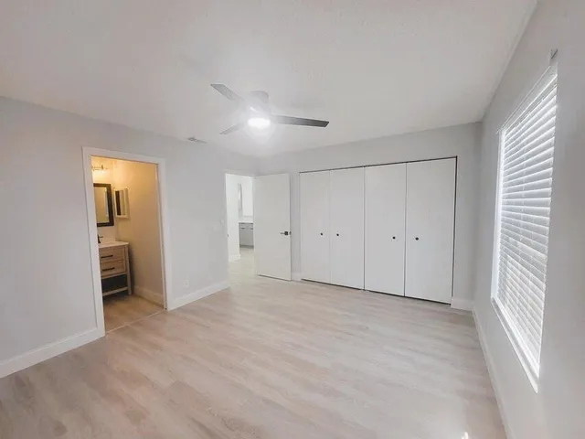 a view of empty room with wooden floor and cabinet