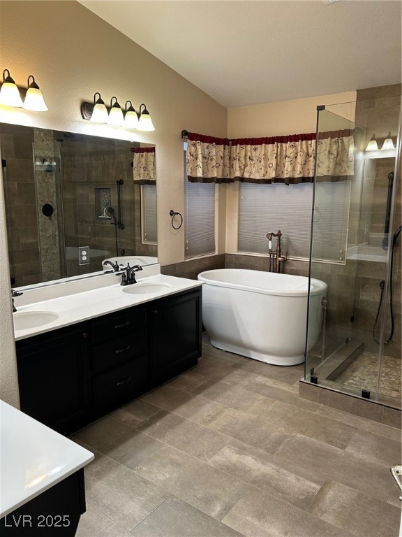 1008 Ridgegate Street Henderson, NV 89002 - Photo 31 of 46 Full master bathroom featuring double vanity, a shower stall, and a freestanding bath
