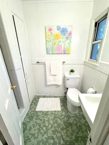 a bedroom with a bed couch and window