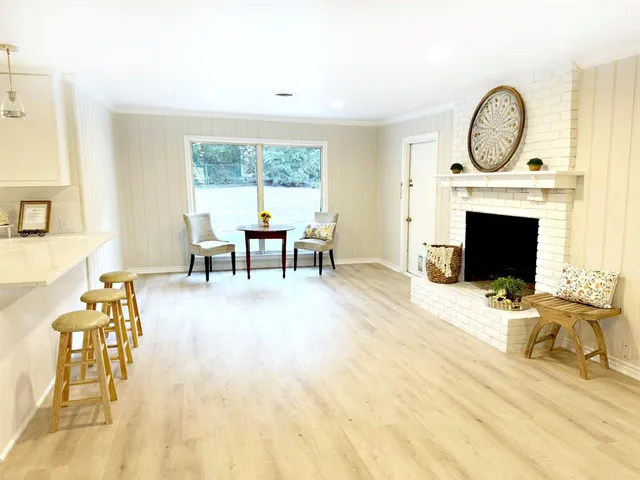 a large kitchen with a lot of cabinets and wooden floor