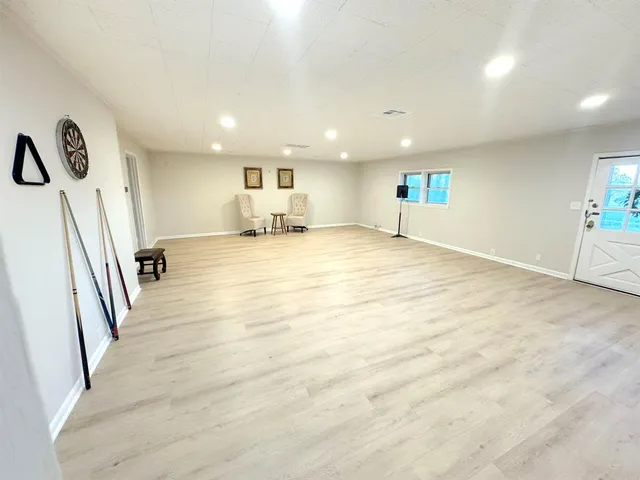 a large kitchen with cabinets a sink and a stove top oven