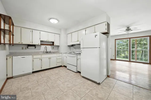 a kitchen with appliances cabinets and a sink