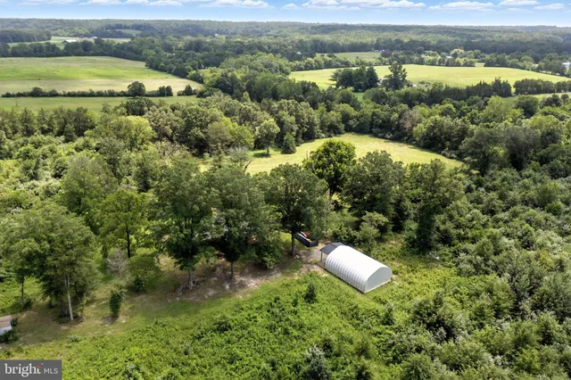 an aerial view of a house with a yard and lake view