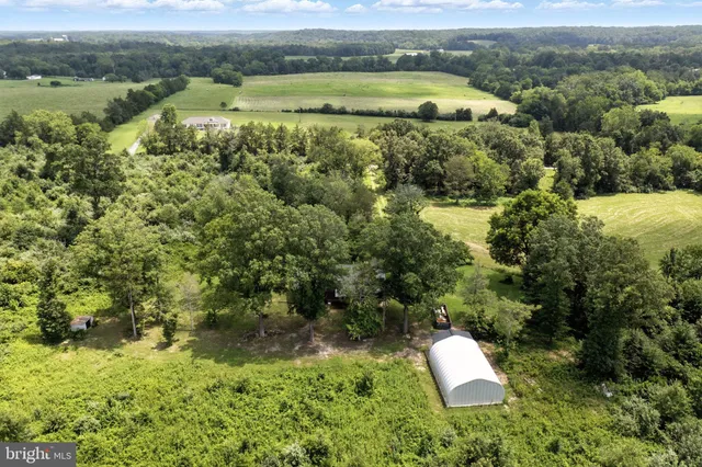 an aerial view of a house with a yard and lake view