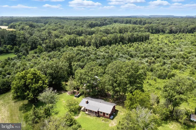 an aerial view of a house with a yard
