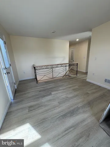 a view of room with wooden floor