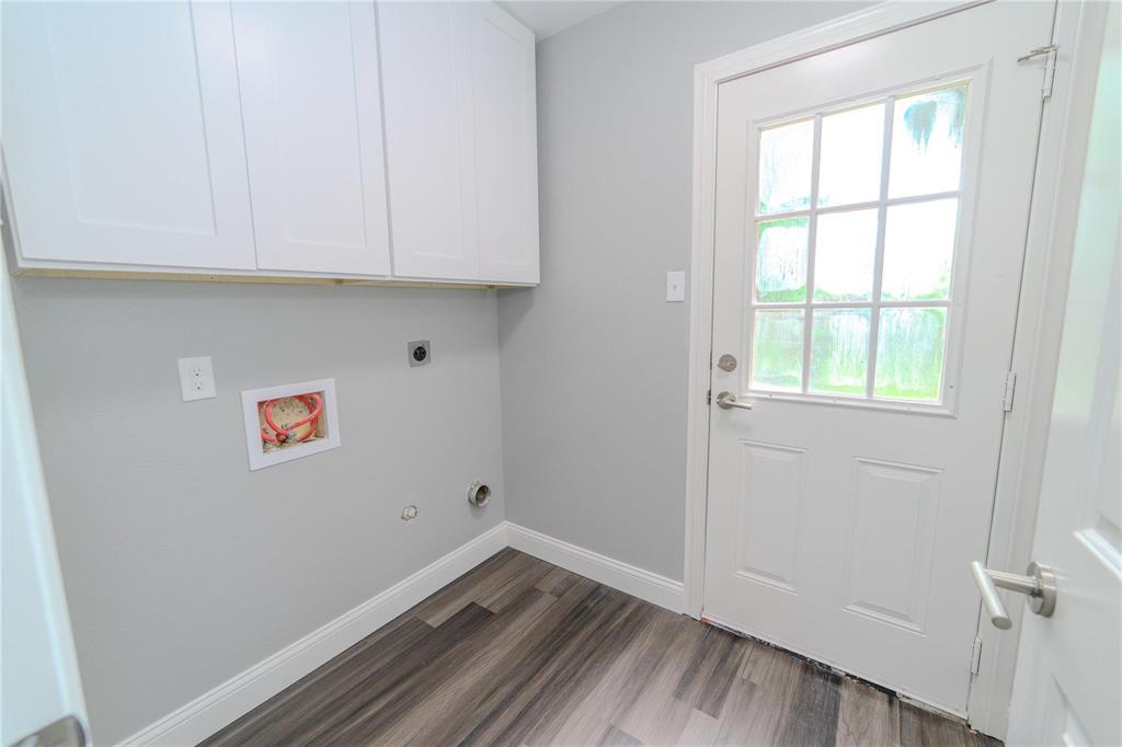 809 Wilcox Street McKinney, TX 75069 - Photo 10 of 26 Laundry room with cabinet space, hookup for a gas dryer, dark wood-style flooring, hookup for an electric dryer, and hookup for a washing machine