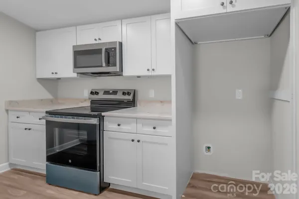 a kitchen with stainless steel appliances white cabinets and a sink