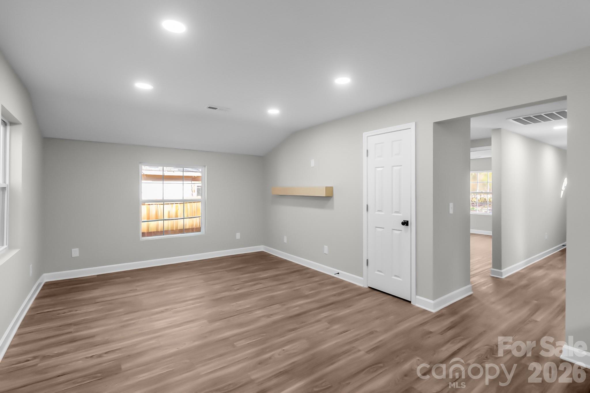 401 Golf Course Road Winnsboro, SC 29180 - Photo 22 of 39 a view of an empty room with wooden floor and a window