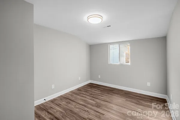 a view of room with wooden floor and window