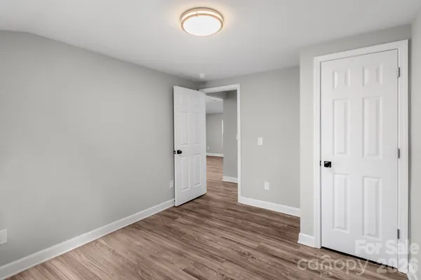 a view of an empty room and wooden floor