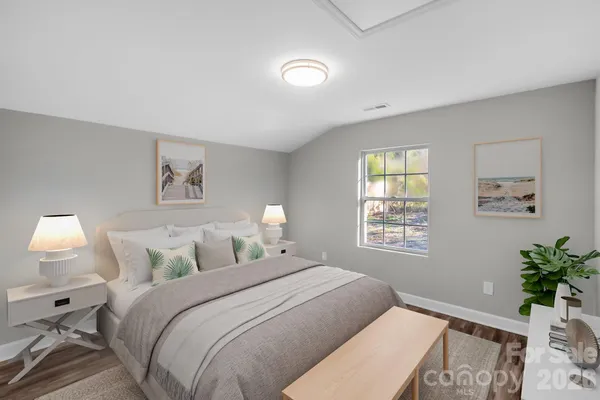 a bedroom with a bed and a potted plant