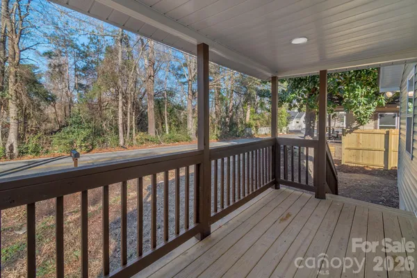 a view of a porch with wooden floor and outdoor space