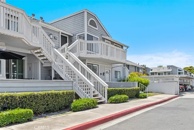 a front view of a house with a garden and plants