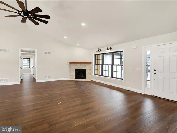 a kitchen with stainless steel appliances kitchen island granite countertop a sink a stove and cabinets