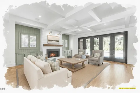 a living room with furniture large window and a fireplace