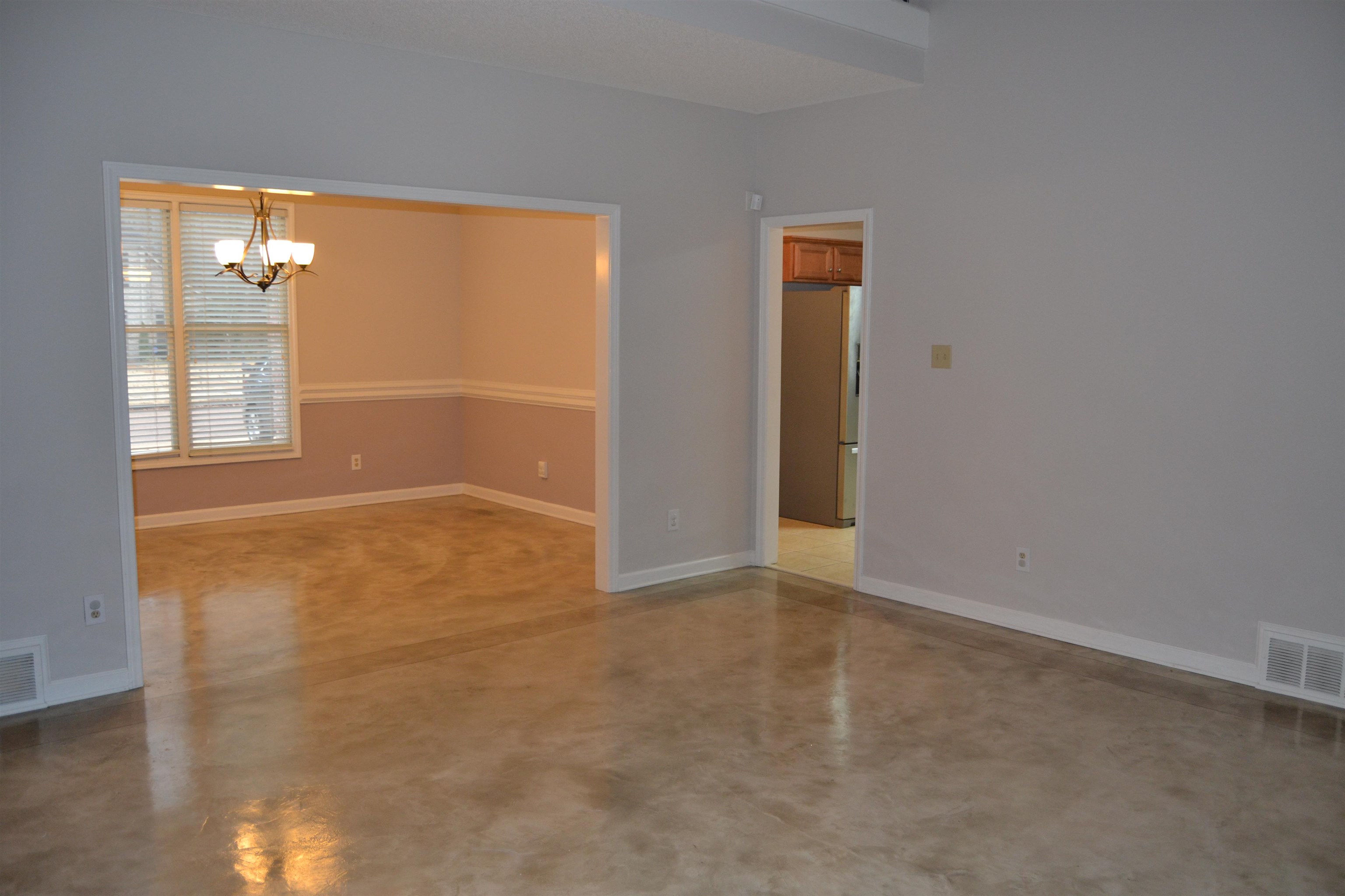 10486 Juneau Way Collierville, TN 38017 - Photo 9 of 33 Unfurnished room with concrete floors and a notable chandelier