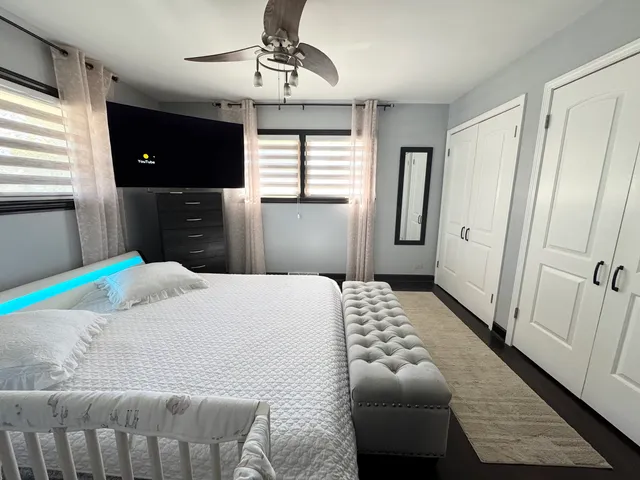 a bedroom with a bed dresser and a window