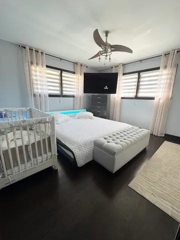 a bedroom with a bed and window