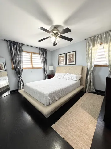 a bedroom with a large bed and a chandelier