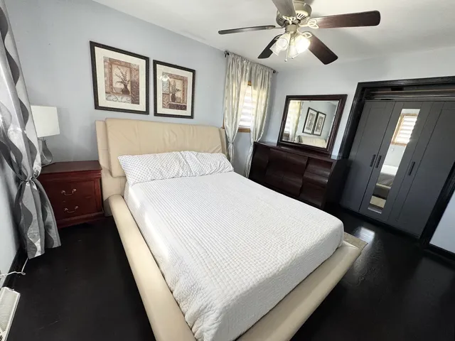 a bedroom with a bed and a mirror