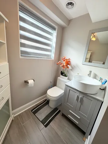 a bathroom with a sink a toilet and mirror