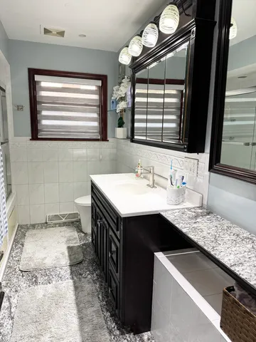 a kitchen with a sink stove and a mirror