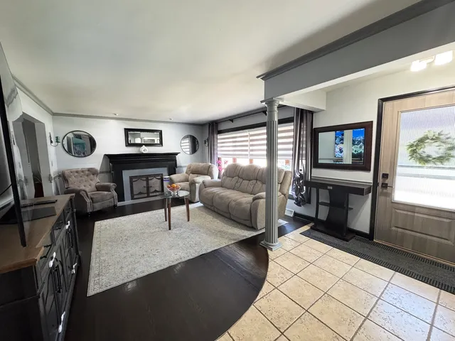 a living room with furniture a fireplace and a flat screen tv