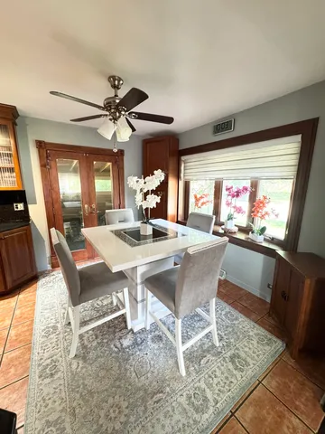 a view of a dining room with furniture a chandelier and wooden floor