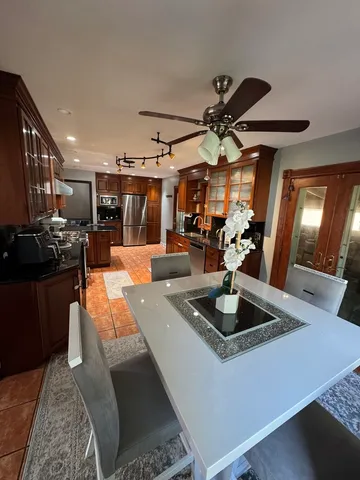 a kitchen with stainless steel appliances granite countertop a sink dishwasher and a stove with wooden floor