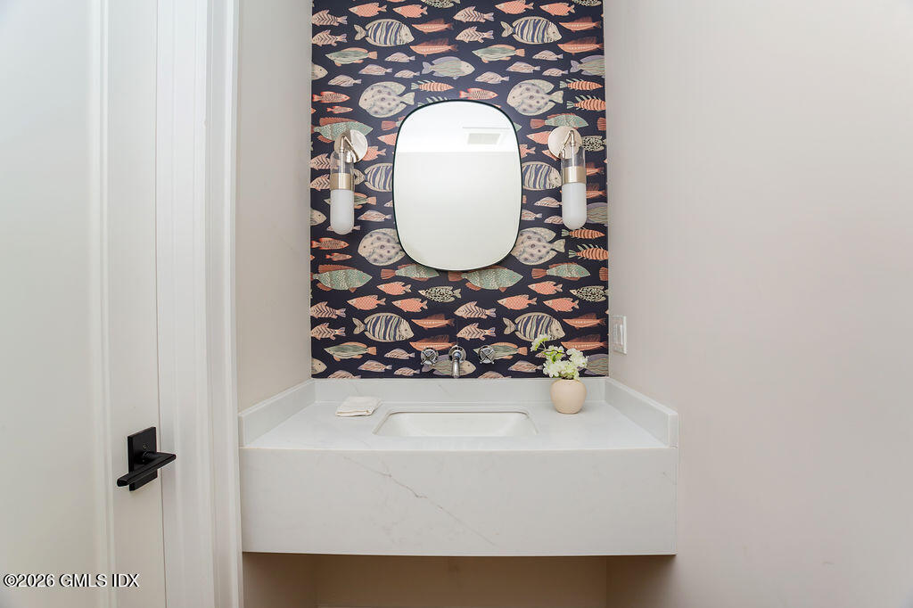 49 Salisbury Road Darien, CT 06820 - Photo 15 of 40 a bathroom with a sink and a mirror