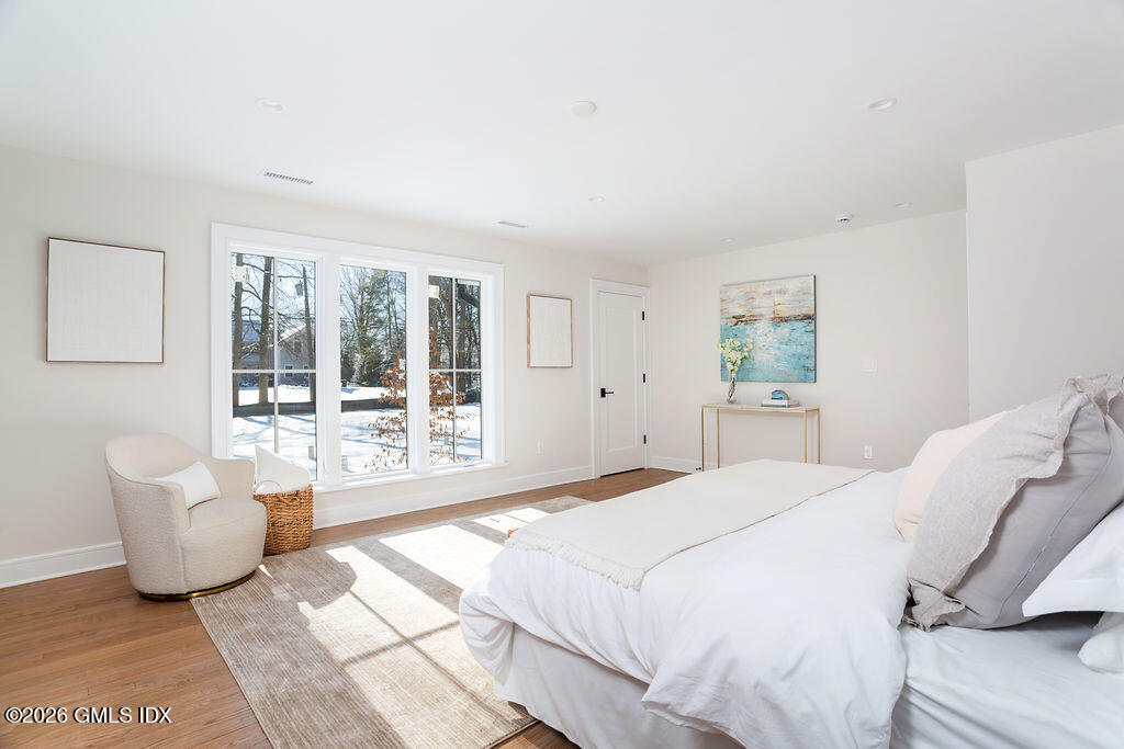 49 Salisbury Road Darien, CT 06820 - Photo 16 of 40 a spacious bedroom with a bed and glass door
