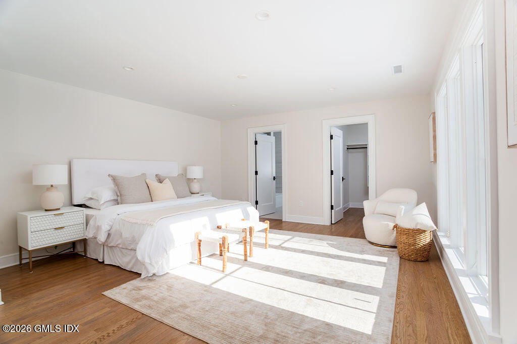 49 Salisbury Road Darien, CT 06820 - Photo 17 of 40 a spacious bedroom with a bed and a lamp