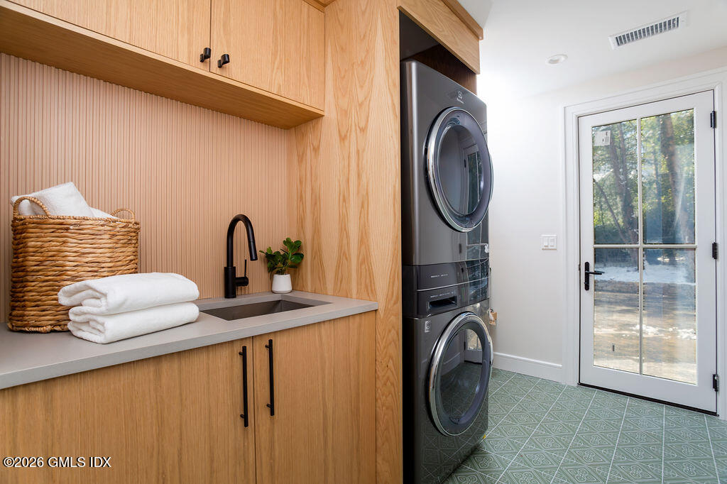 49 Salisbury Road Darien, CT 06820 - Photo 25 of 40 a bathroom with a sink a washer and dryer next to a window