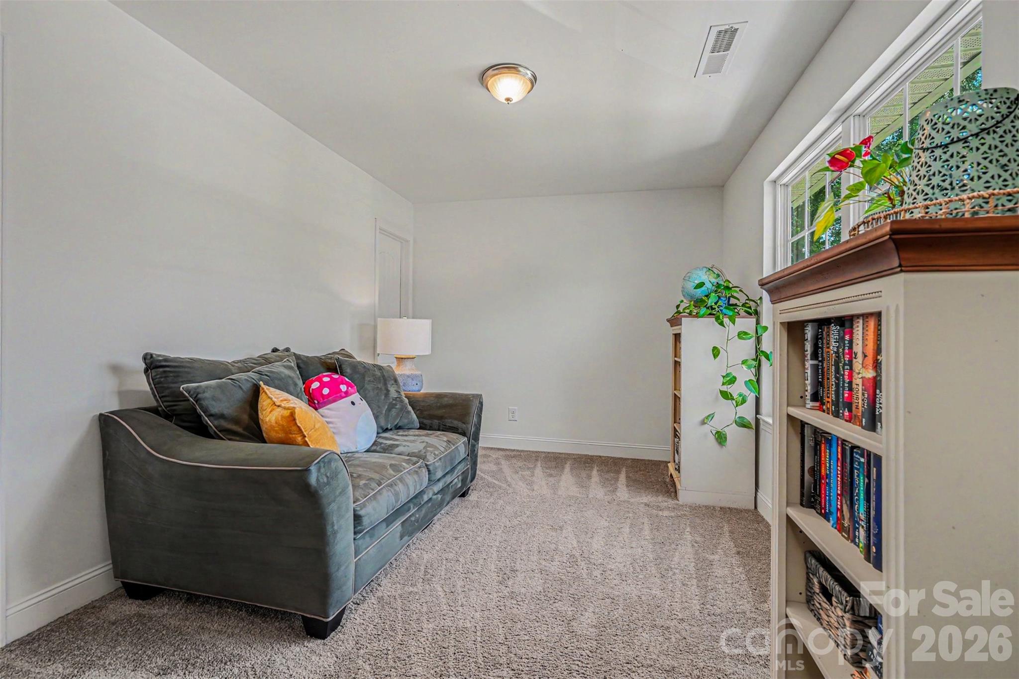 1610 Walter Hasty Road Monroe, NC 28110 - Photo 24 of 32 a living room with furniture and a book shelf