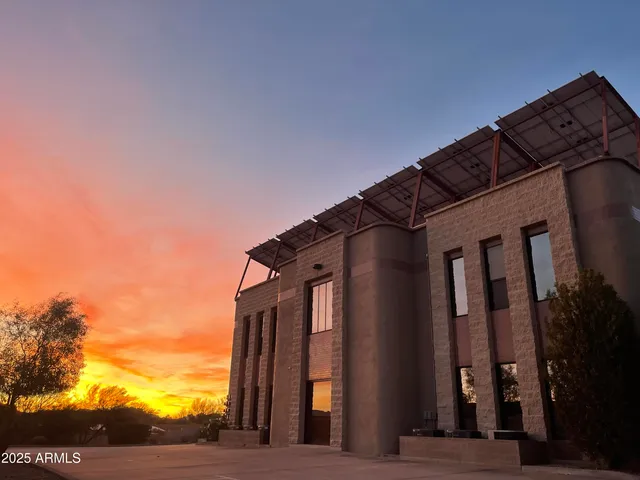 a kitchen with a sink and a stove with wooden floor