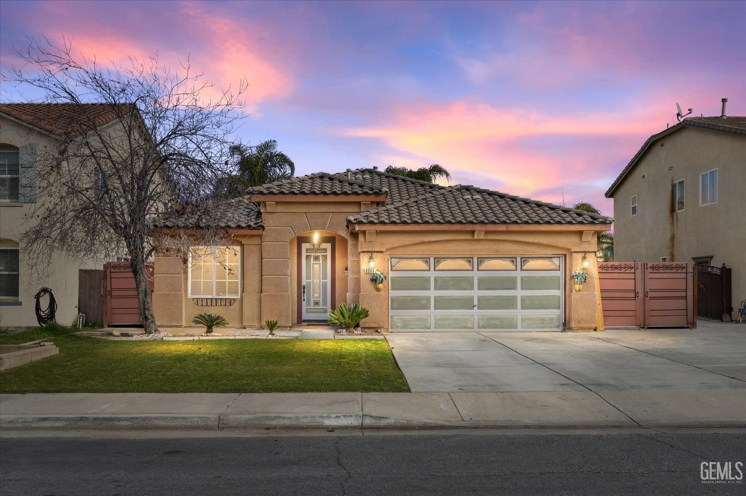 a view of a house with a yard and a garage