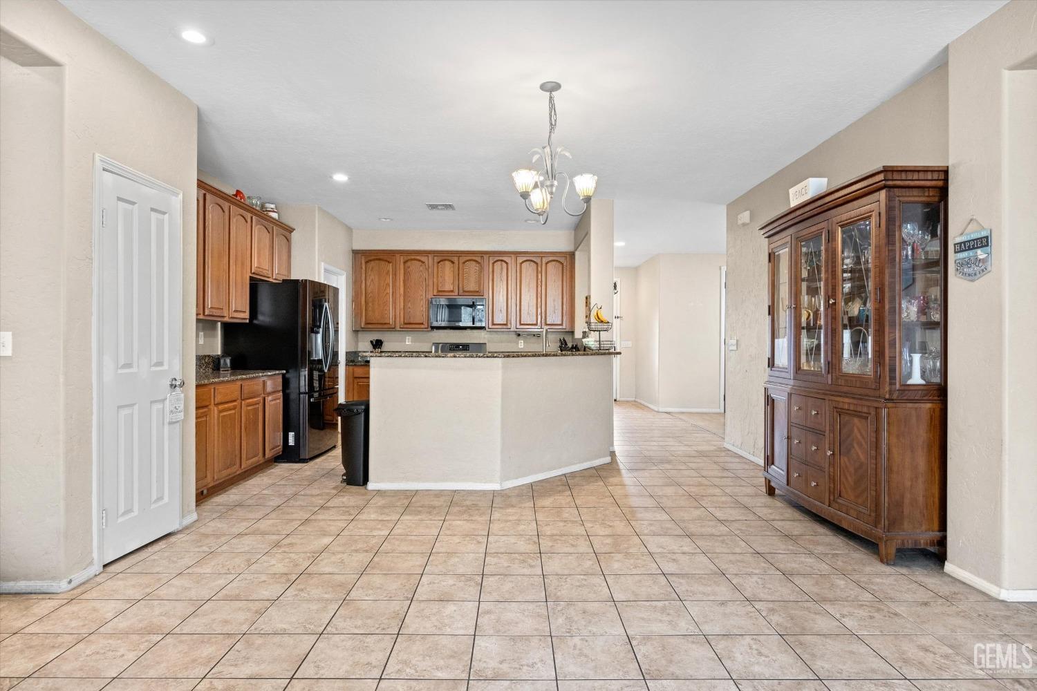 Undisclosed Address Bakersfield, CA 93313 - Photo 11 of 24 a kitchen with stainless steel appliances granite countertop a refrigerator and a stove top oven