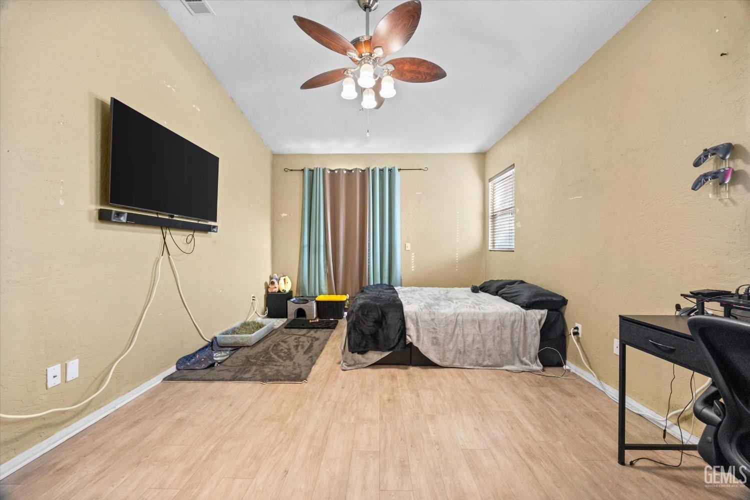 Undisclosed Address Bakersfield, CA 93313 - Photo 19 of 24 a bedroom with a bed and a flat screen tv