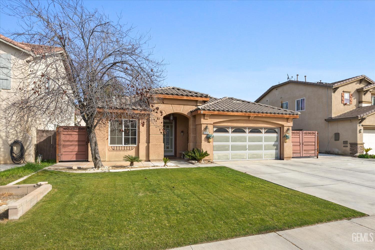 Undisclosed Address Bakersfield, CA 93313 - Photo 2 of 24 a front view of a house with a yard